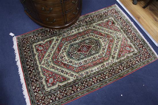 A mathched pair of Qum silk rugs, 5ft 4in by 3ft 4in.